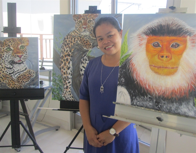 Le Thi Trang poses for a photo at an exhibition on the endangered red-shanked douc langurs (Pygathrix nemaeus) in Đà Nẵng. She and nine other conservationists from around the world have been named ‘Hotspot Heroes’ for their efforts to protect the world’s biodiversity hotspots.