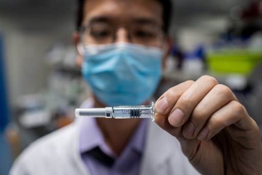 An engineer shows an experimental vaccine against Covid-19 (Photo: AFP)