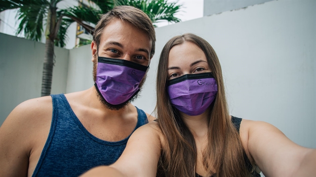 Arijana Tkalcec and her boyfriend Matej Span in the backyard of their rental house in Da Nang