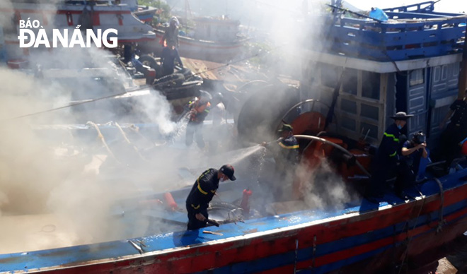 Firefighters battling the fire on board the fishing vessel