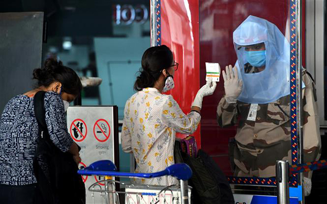  Nhân viên an ninh kiểm tra các hành khách tại sân bay quốc tế Indira Gandhi ở New Delhi, Ấn Độ, ngày 25-5-2020. Ảnh: THX/TTXVN