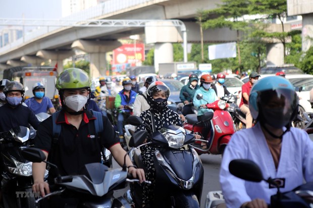 Ha Noi motorcyclists cover up to avoid the summer heat wave.