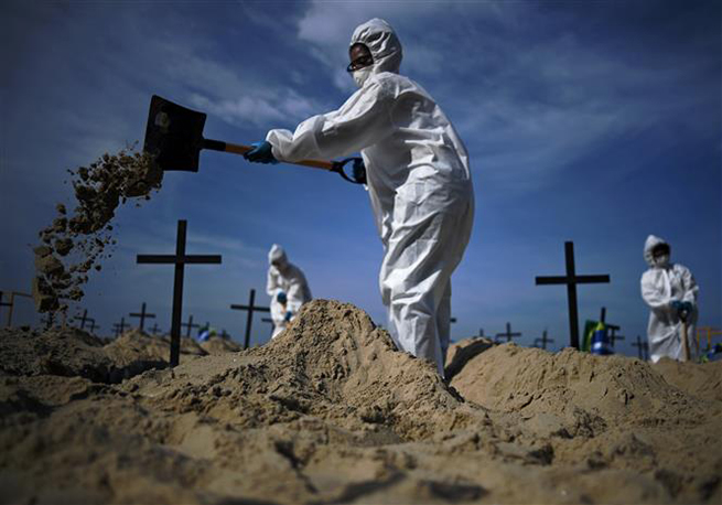  Nhóm tình nguyện đào huyệt mộ giả trên bãi biển Copacabana để tưởng nhớ những người đã tử vong vì dịch Covid-19 tại Rio de Janeiro, Brazil, ngày 11-6-2020. Ảnh: AFP/TTXVN