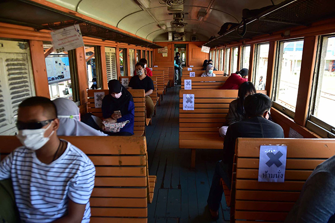 Passengers sit next to empty seats with social distancing signs on a train at Tanyong Mat railway station in the southern Thai province of Narathiwat, on June 11, following the lifting of coronavirus travel restrictions. Madaree Tohlala/AFP/Getty Images