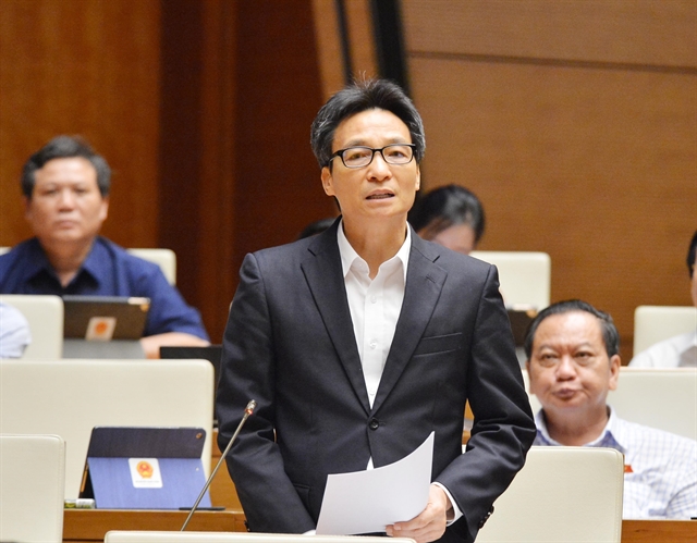 Deputy Prime Minister Vu Duc Dam addresses the National Assembly meeting to discuss socio-economic performance on Saturday