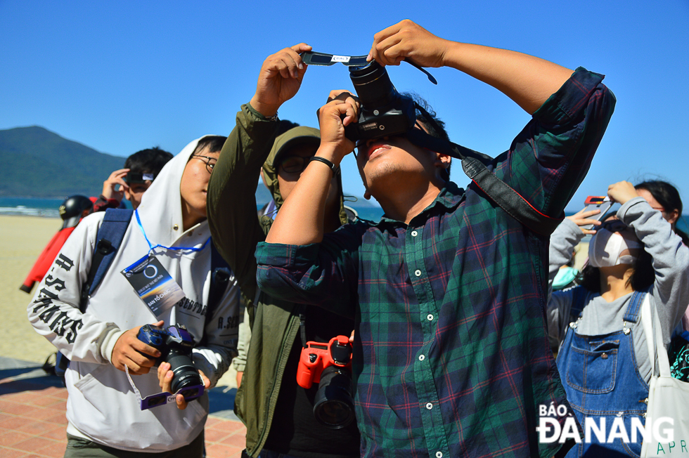 A local photographer using special glasses to capture this annular solar eclipse sequence 