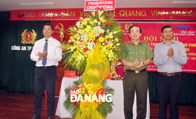 Phó Chủ tịch UBND thành phố Hồ Kỳ Minh (bìa phải) tặng hoa chúc mừng hội nghị. Ảnh: THÀNH LÂN