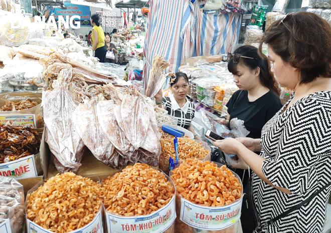 Residents and tourists are seen purchasing dried seafood at the downtown Han Market