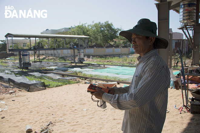 Mr Toan is seen operating his multifunctional gardening system at his own organic vegetable growing area