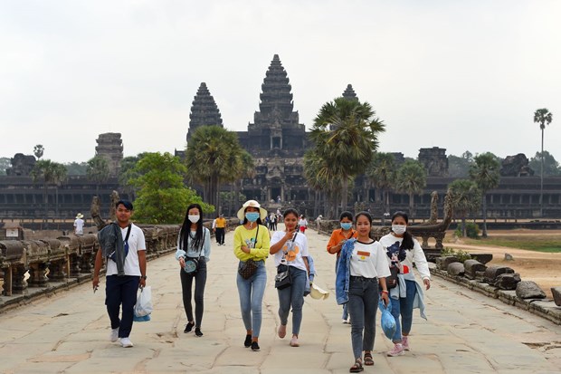 People wear face masks as they visit Angkor Wat in Siem Reap province of Cambodia. (Photo: AFP)