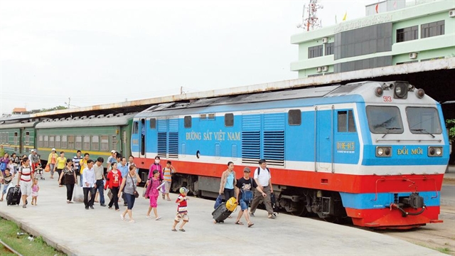 Passengers exit a North-South train operated by the Hanoi Railway Transport JSC. — VNA/VNS Photo