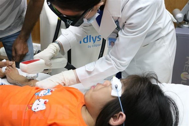 The first patient with Cantú syndrome is treated for hair removal by the doctors in HCM City Hospital of Dermato Venereology. (Photo: VNA)