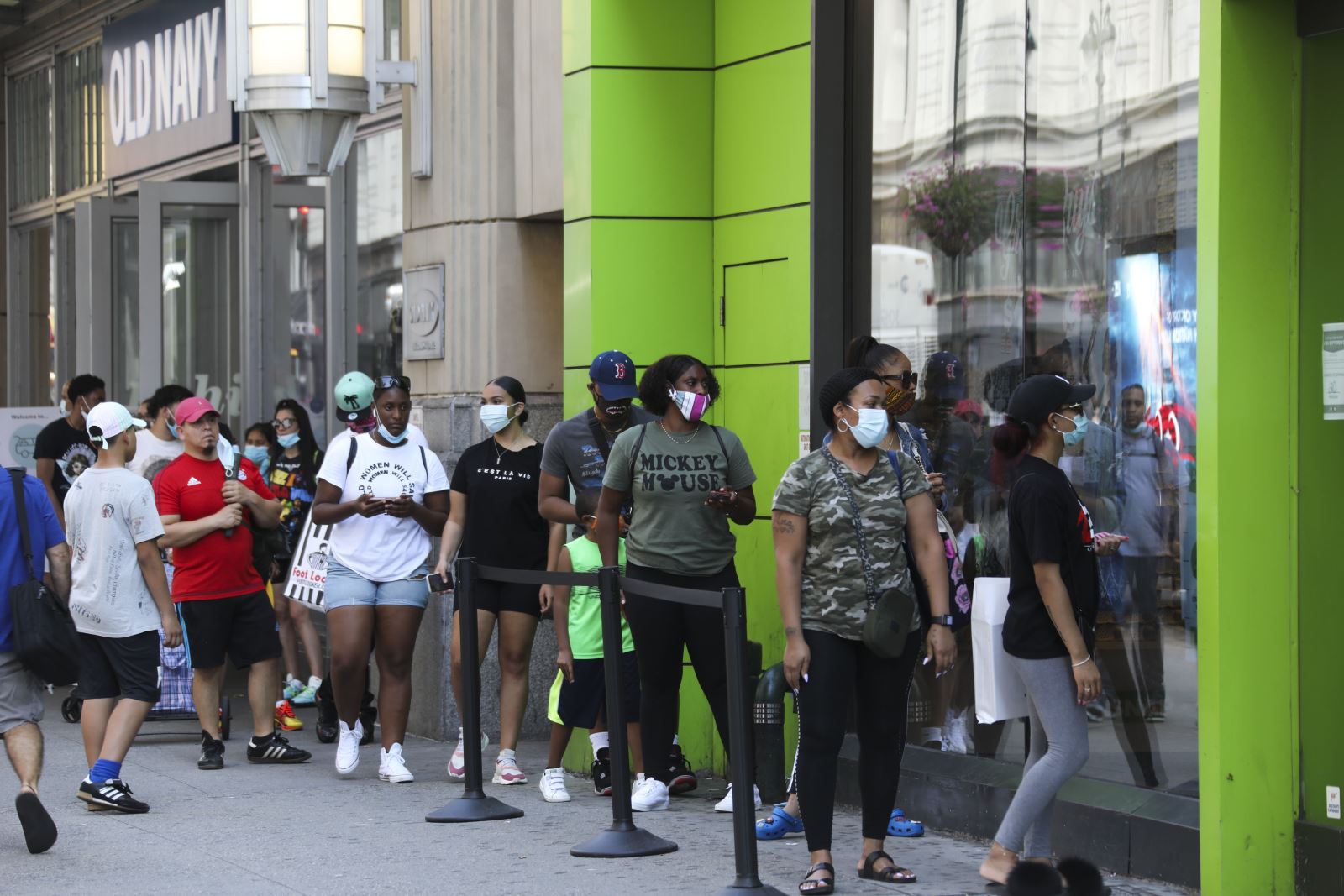  Người dân đeo khẩu trang phòng lây nhiễm COVID-19 khi xếp hàng bên ngoài một cửa hàng ở New York, Mỹ, ngày 14/7/2020. Ảnh: THX/ TTXVN