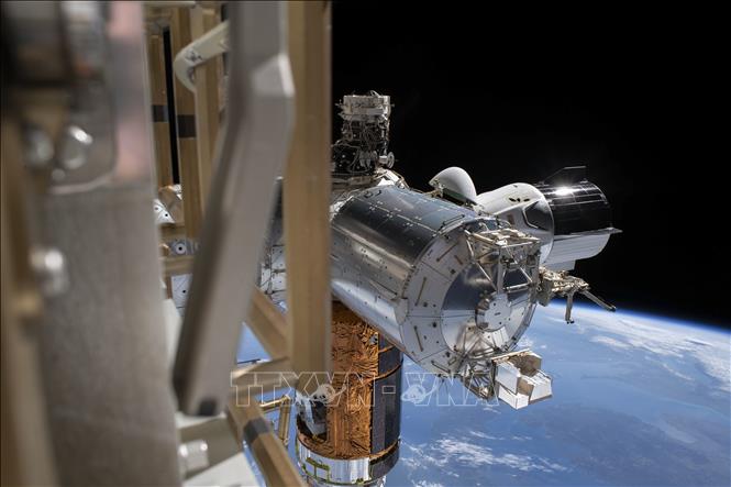 Tàu vũ trụ Crew Dragon của SpaceX (phải) ngoài không gian, ngày 1-7-2020. Ảnh: AFP/ TTXVN