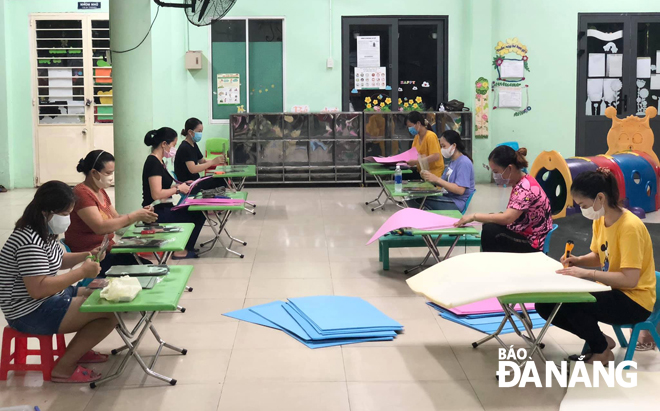 Teachers at the 19 May Preschool making face shields for front liners