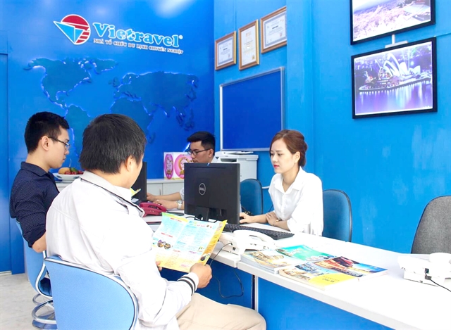 Staff at a Vietravel branch in Hà Nội. Vietravel (VTR) reported revenue of VNĐ206 billion and a loss of VNĐ38 billion in Q2. — Photo vietravel.com