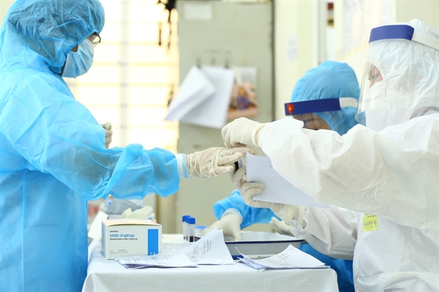 On August 1, health workers in Hà Nội conducted rapid COVID-19 tests for those returning from the central city of Đà Nẵng, which has become Việt Nam's coronavirus hot spot. — VNA/VNS Photo Minh Quyết