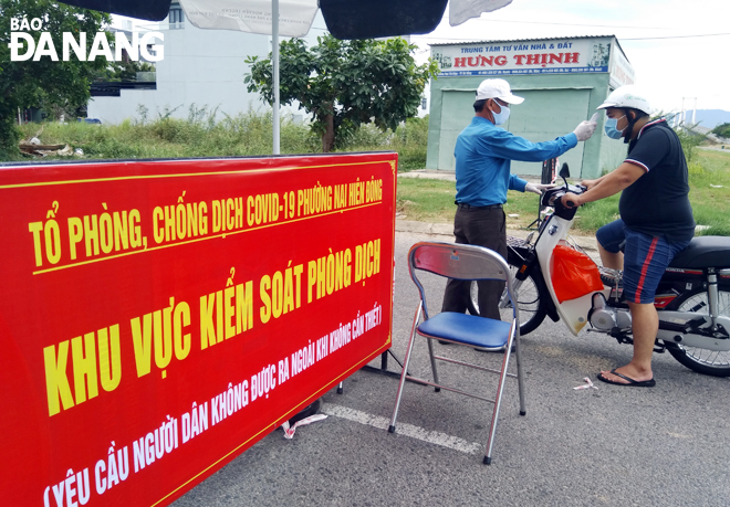 Daily on-site body temperature measurement being underway at local checkpoints