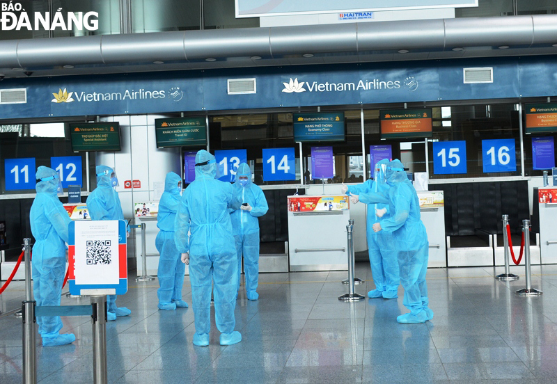 Airport staff wearing protective suits 