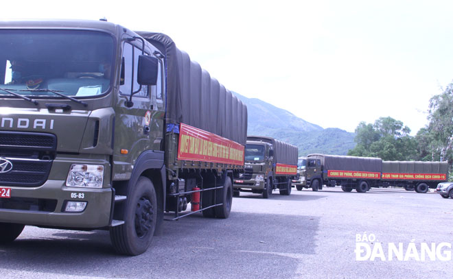 Military trucks on their way to a warehouse of the Da Nang University of Medicine and Pharmacy