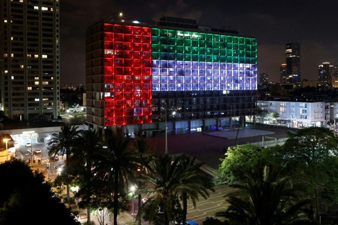 Tòa thị chính thành phố Tel Aviv (Israel) được thắp sáng bằng ánh đèn theo màu cờ của UAE. 								             Ảnh: AP