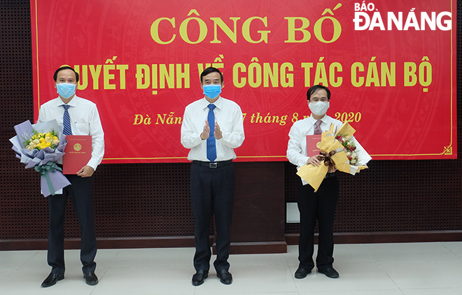 Phó Chủ tịch UBND thành phố Lê Trung Chinh trao quyết định bổ nhiệm cán bộ cho hai ông Huỳnh Huy Hòa và Đặng Đình Đức. ẢNH: S.TRUNG