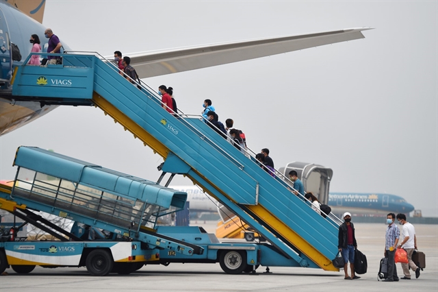 Passengers enter a Vietnam Airlines aircraft at Nội Bài International Airport. — Photo Vietnam Airlines