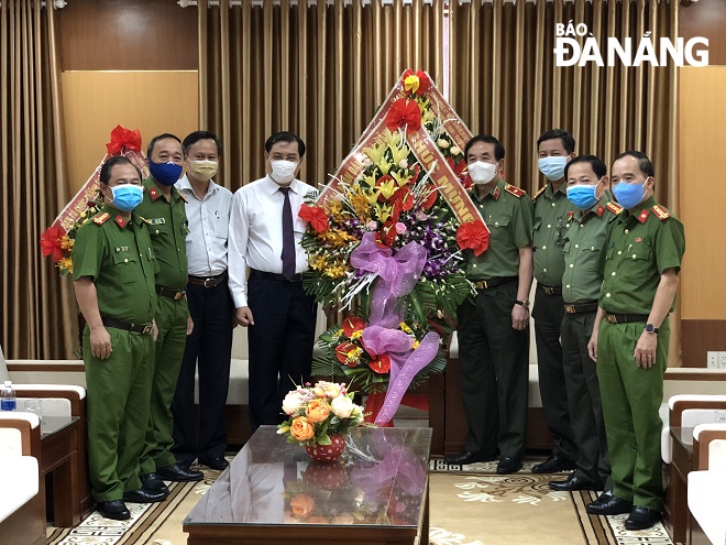 Chủ tịch UBND thành phố Huỳnh Đức Thơ tặng hoa Đảng ủy, Ban Giám độc Công an thành phố Đà Nẵng. Ảnh: NGỌC ĐOAN