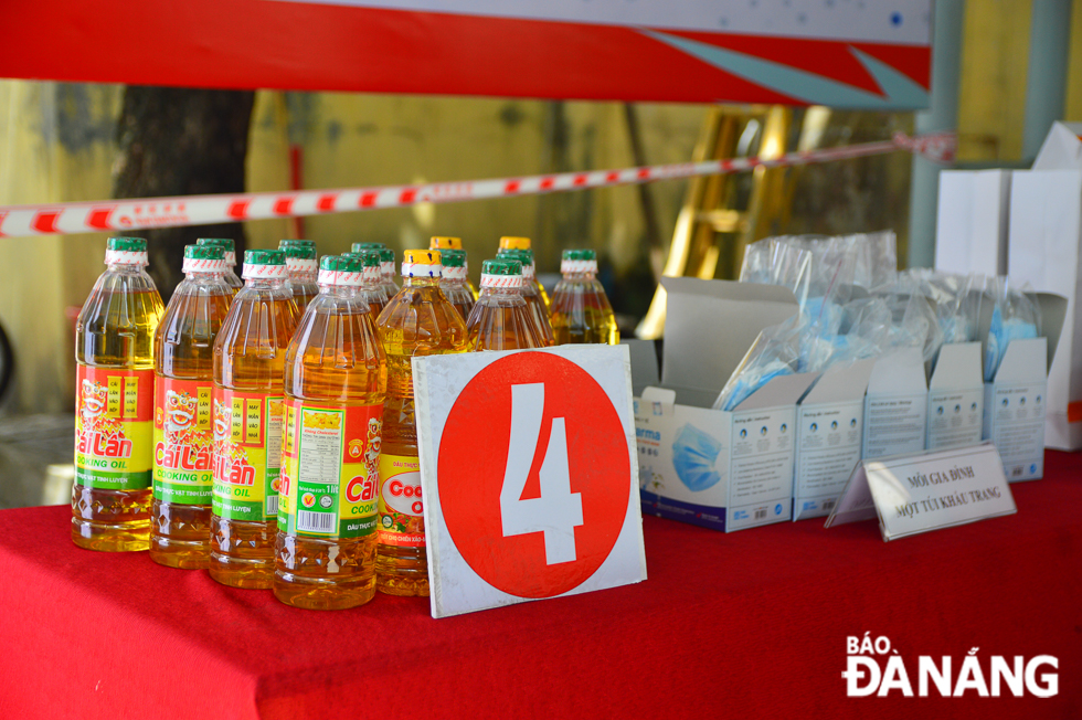 After receiving free rice from the rice dispenser, people are allowed to take cooking oil, surgical masks and another gift placed on a table nearby the rice ATM.