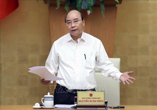 Prime Minister Nguyen Xuan Phuc delivering his instructions on the disbursement of public investment at the Friday teleconference (Photo: VNA)