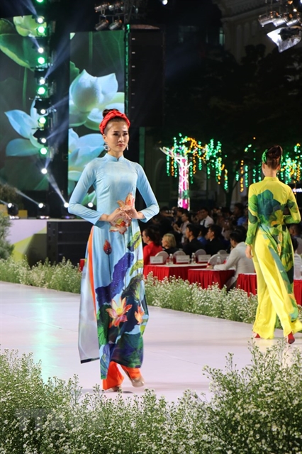 Models in áo dài (Vietnamese traditional dress) at a fashion show, one of highlights of the 6th Áo Dài Festival in HCM City last year. — VNA/VNS Photo