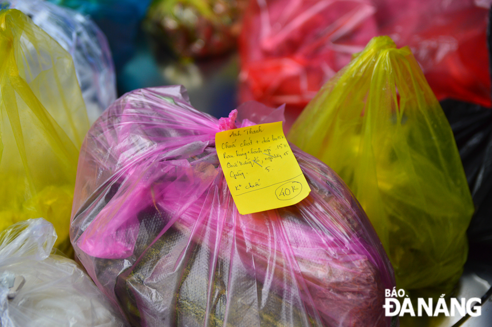 Each food parcels bearing notes on the recipient's name and the purchased items