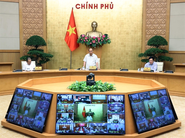 Prime Minister Nguyen Xuan Phuc chairs an online meeting on Covid-19 prevention and control on Thursday