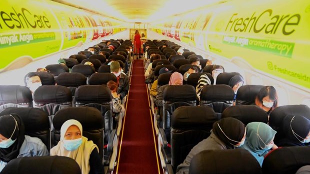 Passengers wearing face masks as a preventive measure against the coronavirus prepare to depart to Jakarta from Kuala Lumpur international airport on Aug 21, 2020. (Photo: AFP)