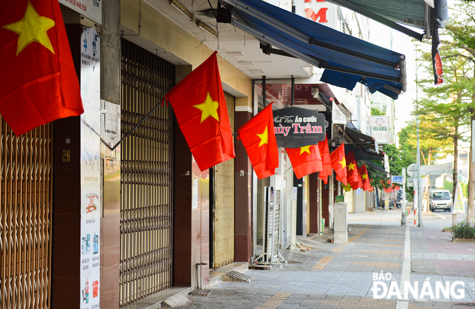  A corner of specialised shopping area on Dien Bien Phu Street festooned in red flags