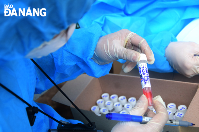 Medical workers carefully re-checking the residents’ personal information recorded on their samples