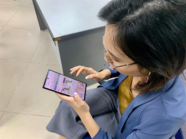 A woman browses an e-commerce website on her phone for hair products. 