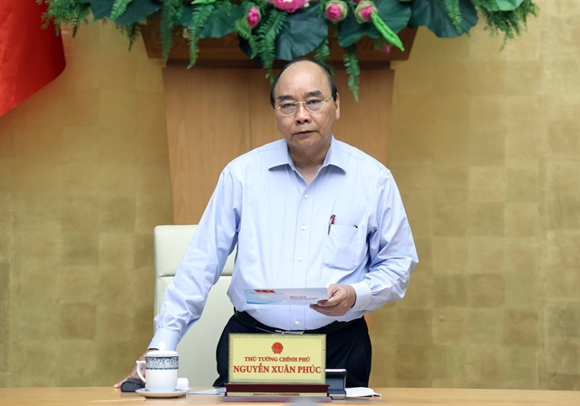 Prime Minister Nguyễn Xuân Phúc speaks at a meeting of the cabinet with the National Steering Committee on COVID-19 Prevention and Control on Friday. VNA/VNS Photo Thống Nhất