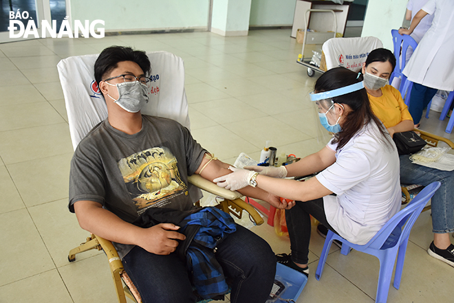 A young man is seen donating his blood at the Friday drive 
