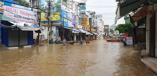 Water floods a street of Ái Nghĩa town in Quảng Nam Province. More than 1,600 local people in flood-affected areas were taken to safe shelters as of Sunday