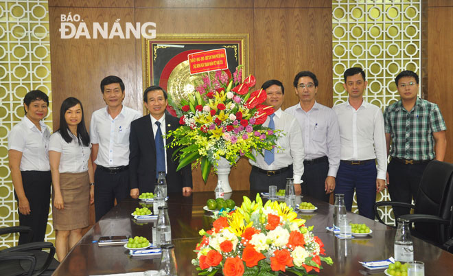 Chủ tịch HĐND thành phố Nguyễn Nho Trung ( người thứ 4 từ phải sang) tặng hoa chúc mừng Tổng Công ty CP Dệt may Hòa Thọ. Ảnh: THÀNH LÂN