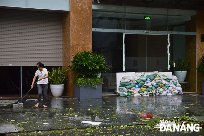  Hotel staff on Tran Phu Street cleaning up after the storm