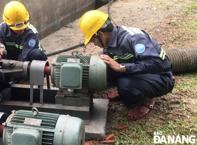 Công nhân Công ty Thoát nước và Xử lý nước thải Đà Nẵng lắp đặt 2 máy bơm công suất lớn để tiêu nước cho hồ Công viên 29 Tháng 3, phục vụ vận hành liên hồ để chống ngập úng ở trung tâm thành phố. 					 Ảnh: HOÀNG HIỆP