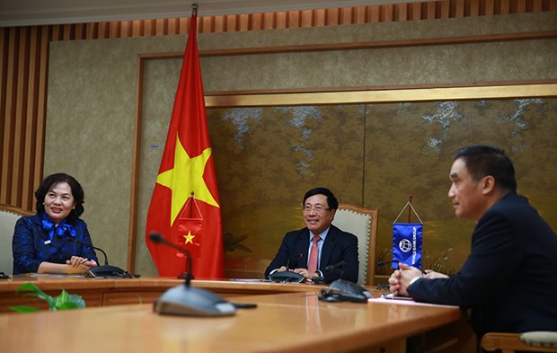 Deputy Prime Minister and Foreign Minister Pham Binh Minh has an online working session with WB Managing Director of Operations Axel van Trotsenburg. (Photo: VGP)