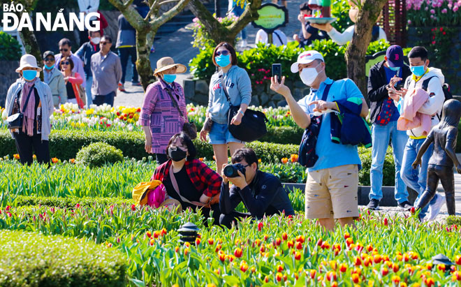 Ngành du lịch thành phố đang triển khai nhiều chương trình ưu đãi, kích cầu để thu hút du khách.  TRONG ẢNH: Du khách tham gia lễ hội hoa tulip tại Khu du lịch Sun World Bà Nà Hills tháng 7-2020. Ảnh: KIM LIÊN
