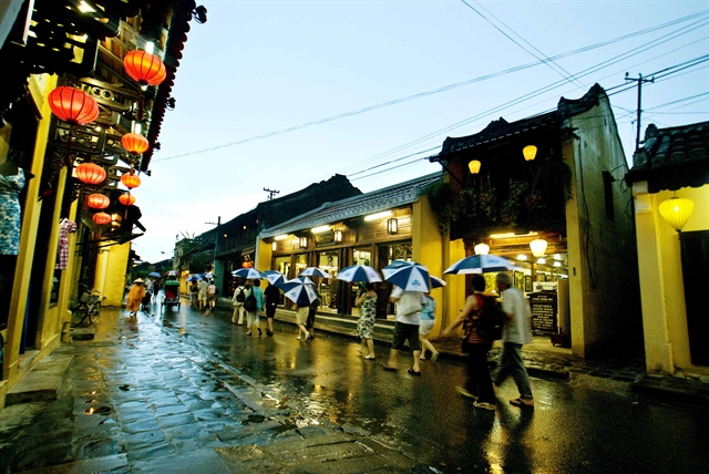 Tourists walk through the Old Quarter of Hội An at night. A series activities will be held in Hội An in celebration of the town's Heritage Day. Photo courtesy of Hội An Culture and Sports Centre