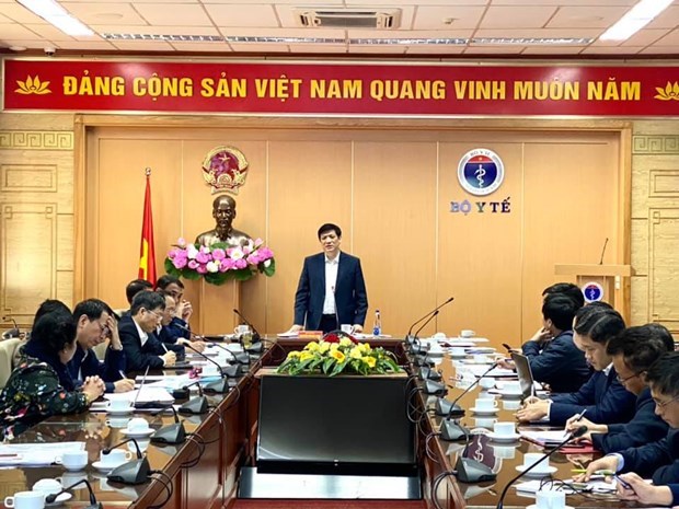 Minister of Health Nguyen Thanh Long (standing) at the meeting with Vietnamese vaccine producers on December 5 (Photo: VNA).