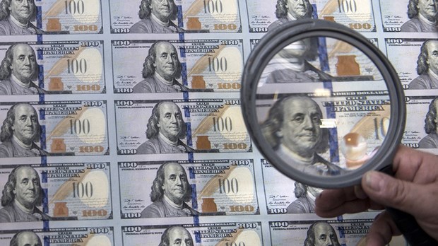 One hundred dollar notes are seen in this photo illustration (Source: AFP)