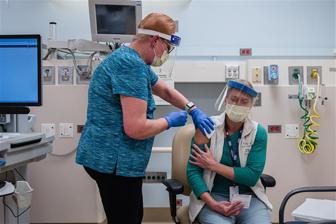 Một nhân viên y tế được tiêm vaccine ngừa Covid-19 tại Southfield, bang Michigan, Mỹ ngày 15-12-2020. Ảnh: AFP/TTXVN
