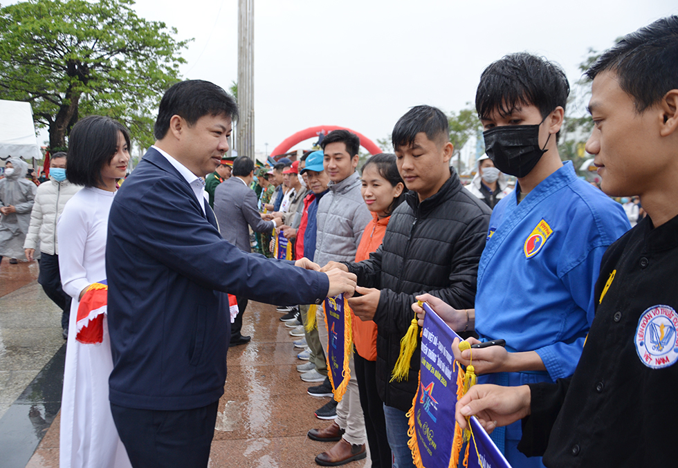 Da Nang Party Committee Deputy Secretary cum municipal People’s Council Chairman Luong Nguyen Minh Triet presenting souvenir flag to representatives from the groups of participating runners